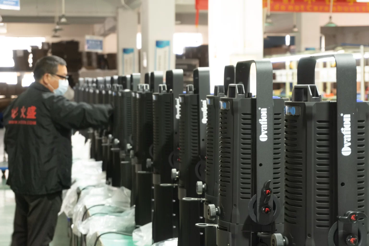 Ovation Led profiles in production line inspected by man wearing mask