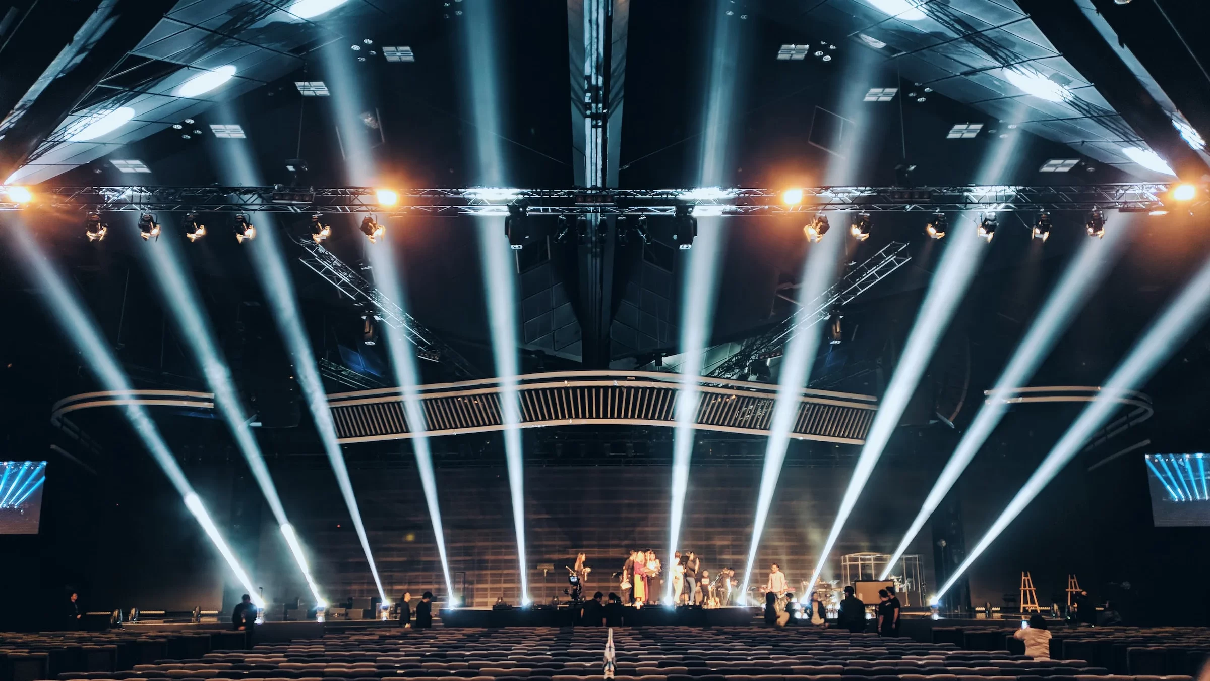 People walking on brown wooden stairs on stage light